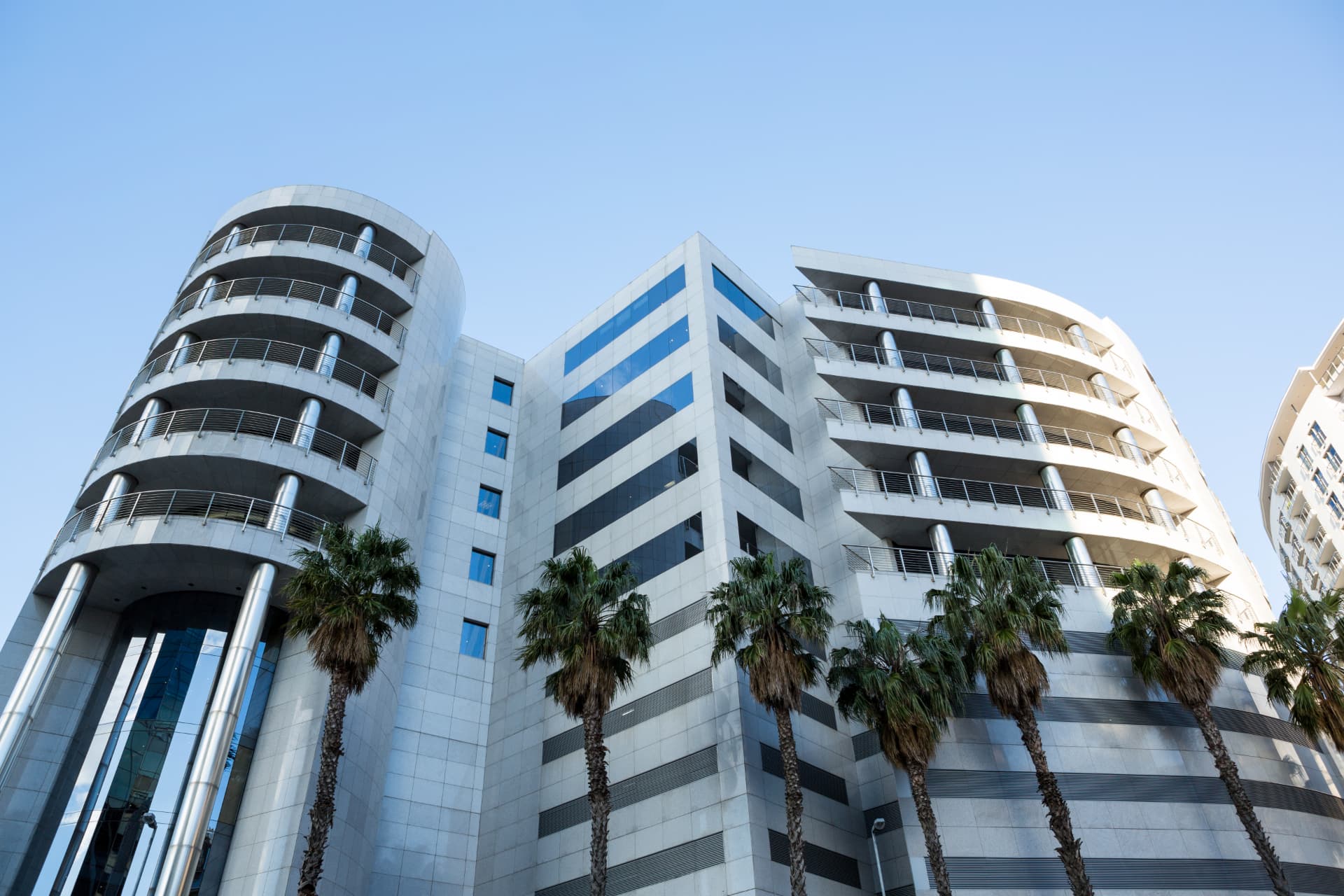 Modern commercial office building with curved glass balconies